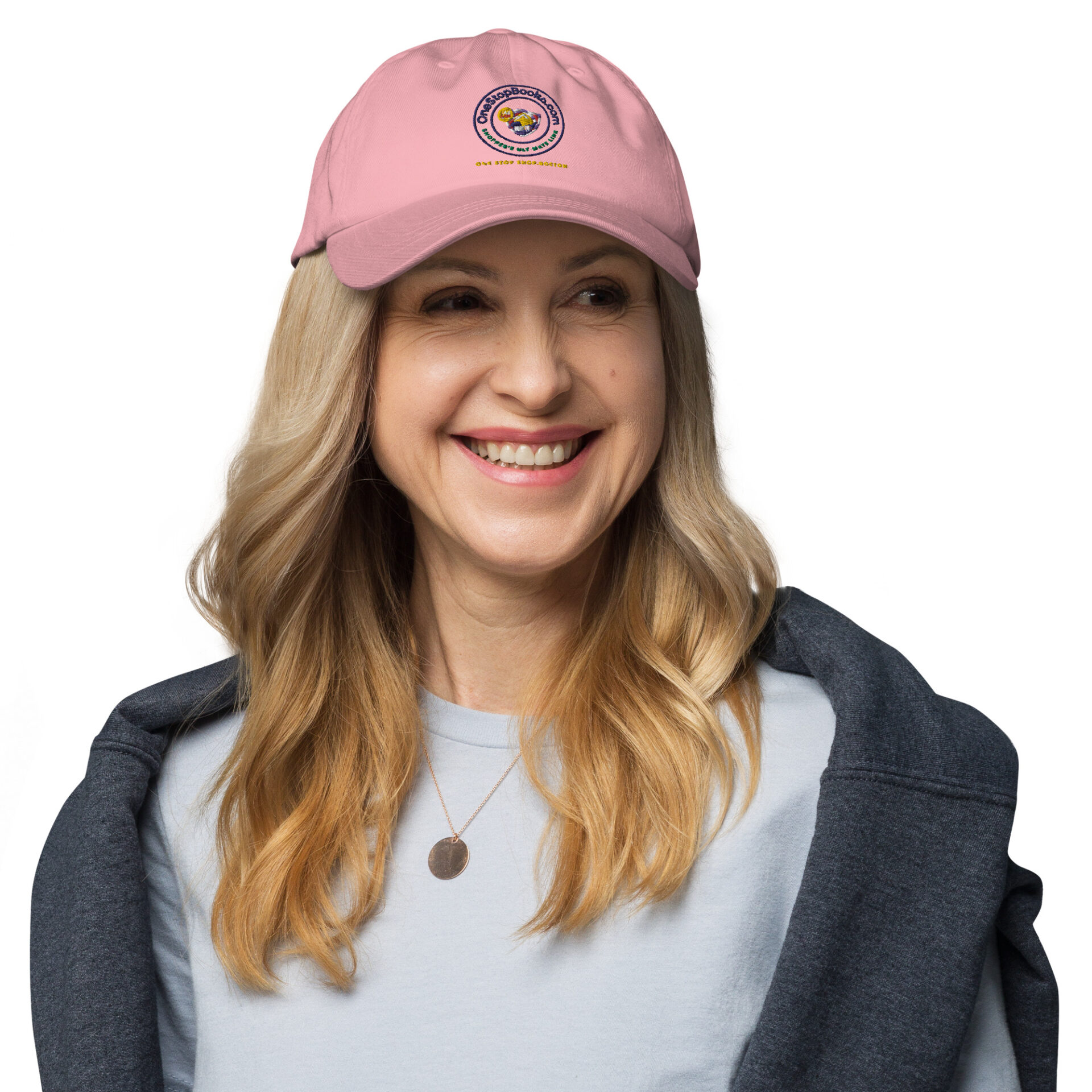 Woman smiling wearing a pink hat.