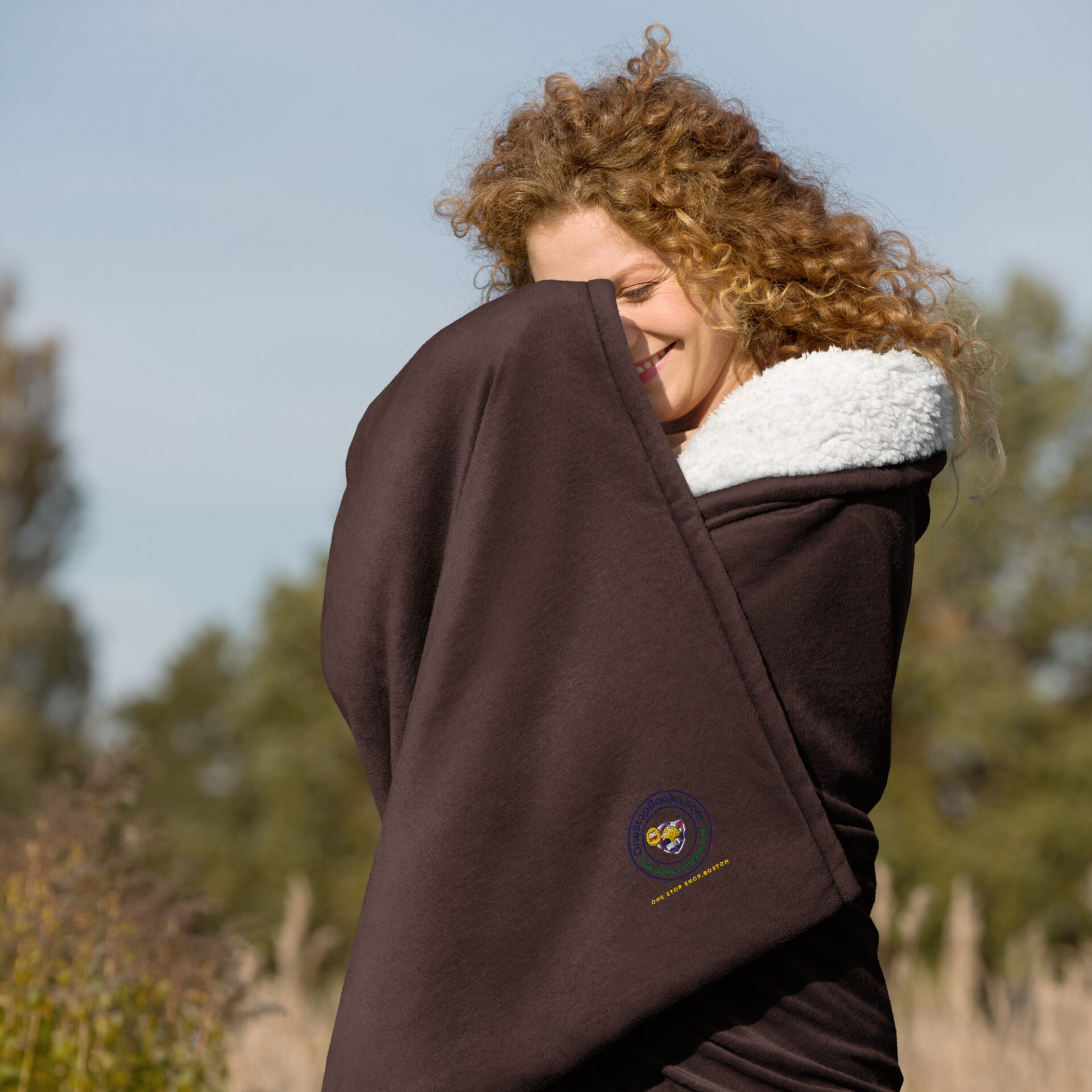 Woman wrapped in a brown blanket.
