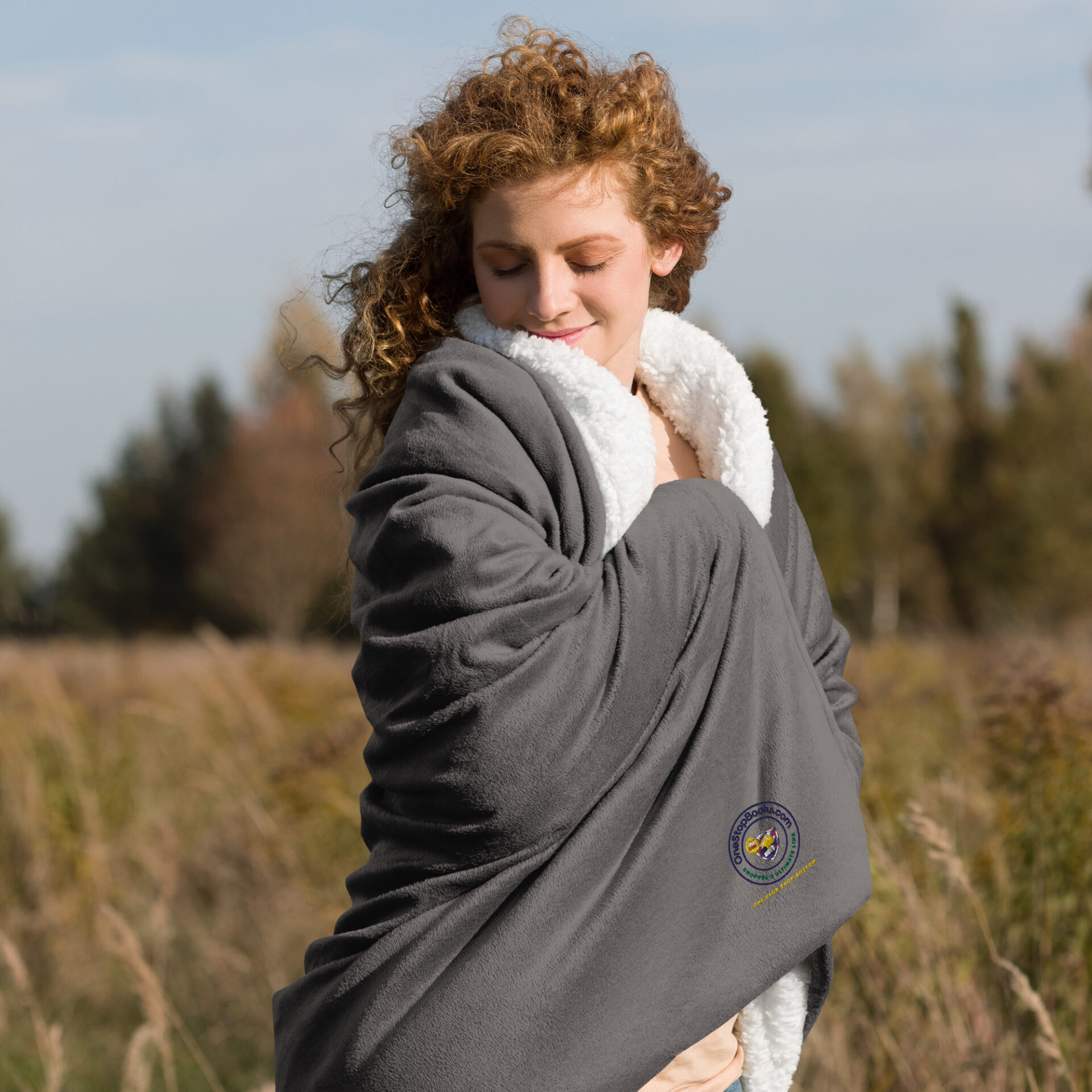 Woman wrapped in a gray blanket.