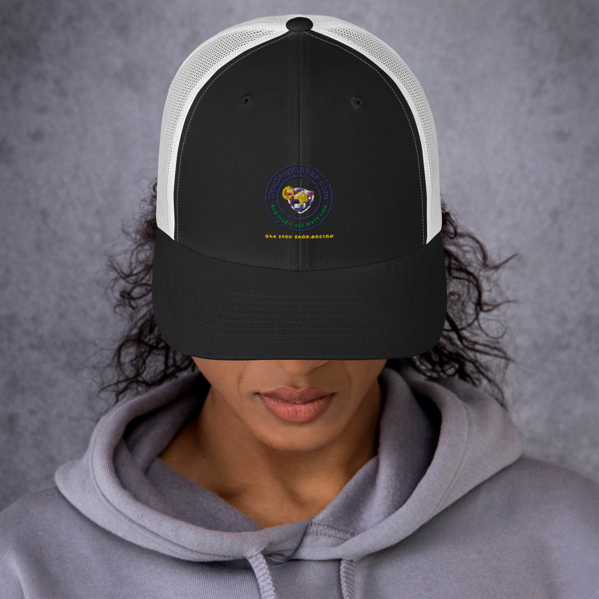 Person wearing a black and white trucker hat.