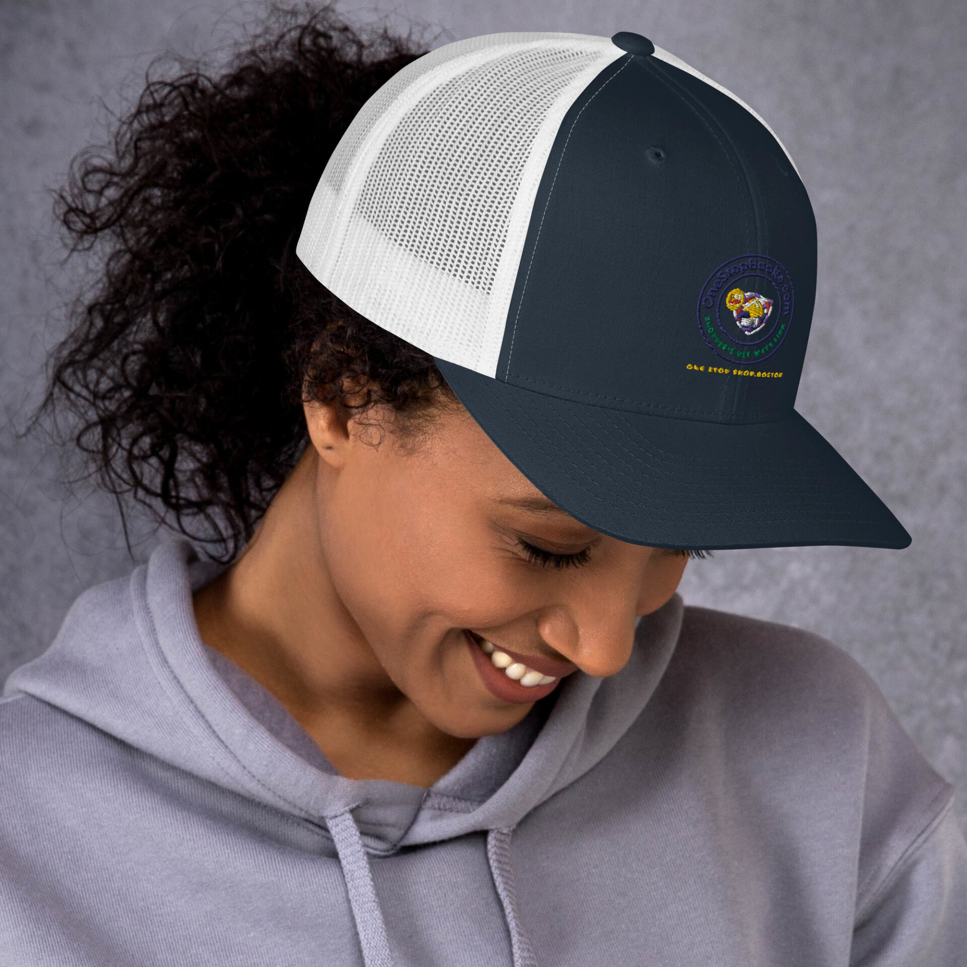 Woman wearing a navy blue and white hat.