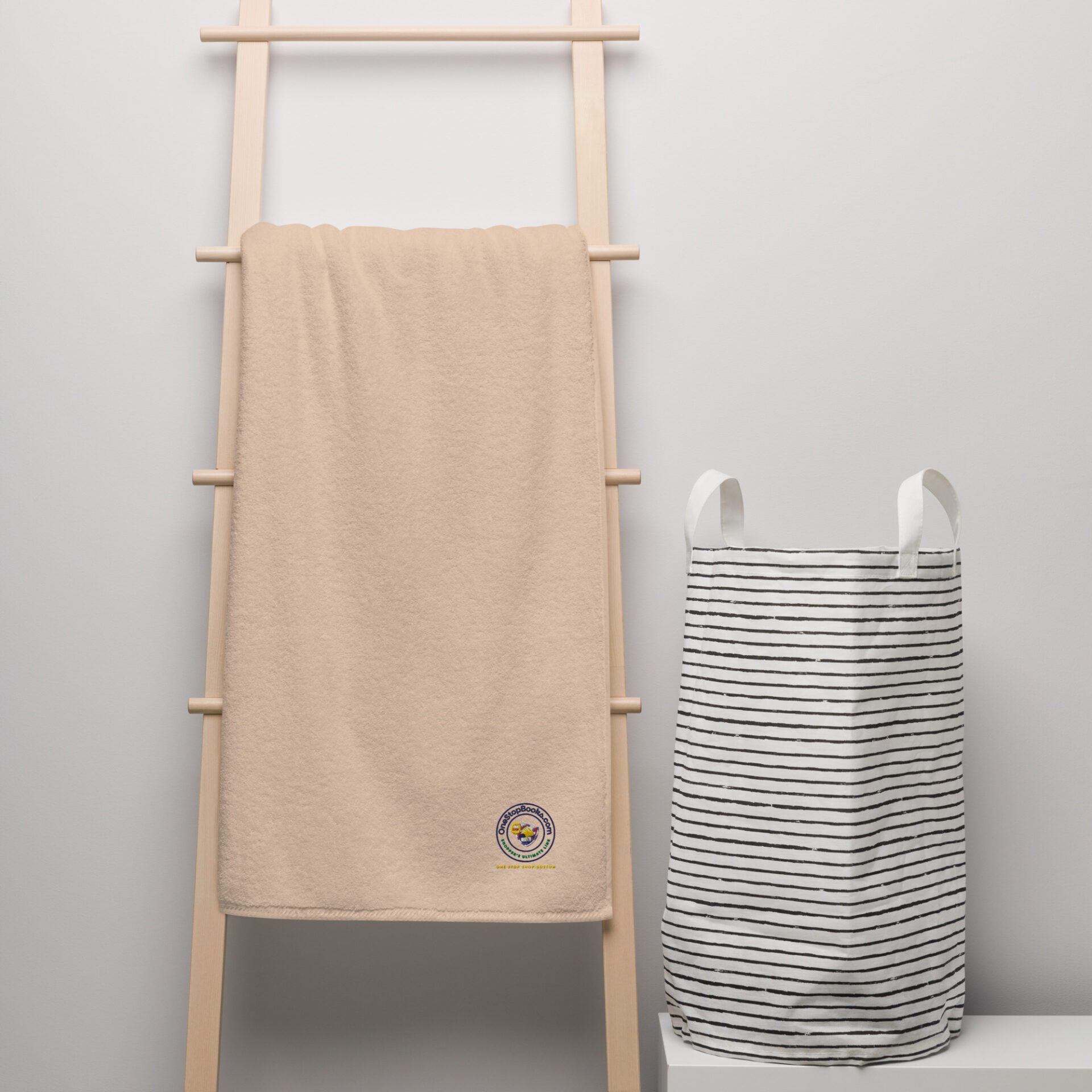 Beige towel hanging on a wooden rack.