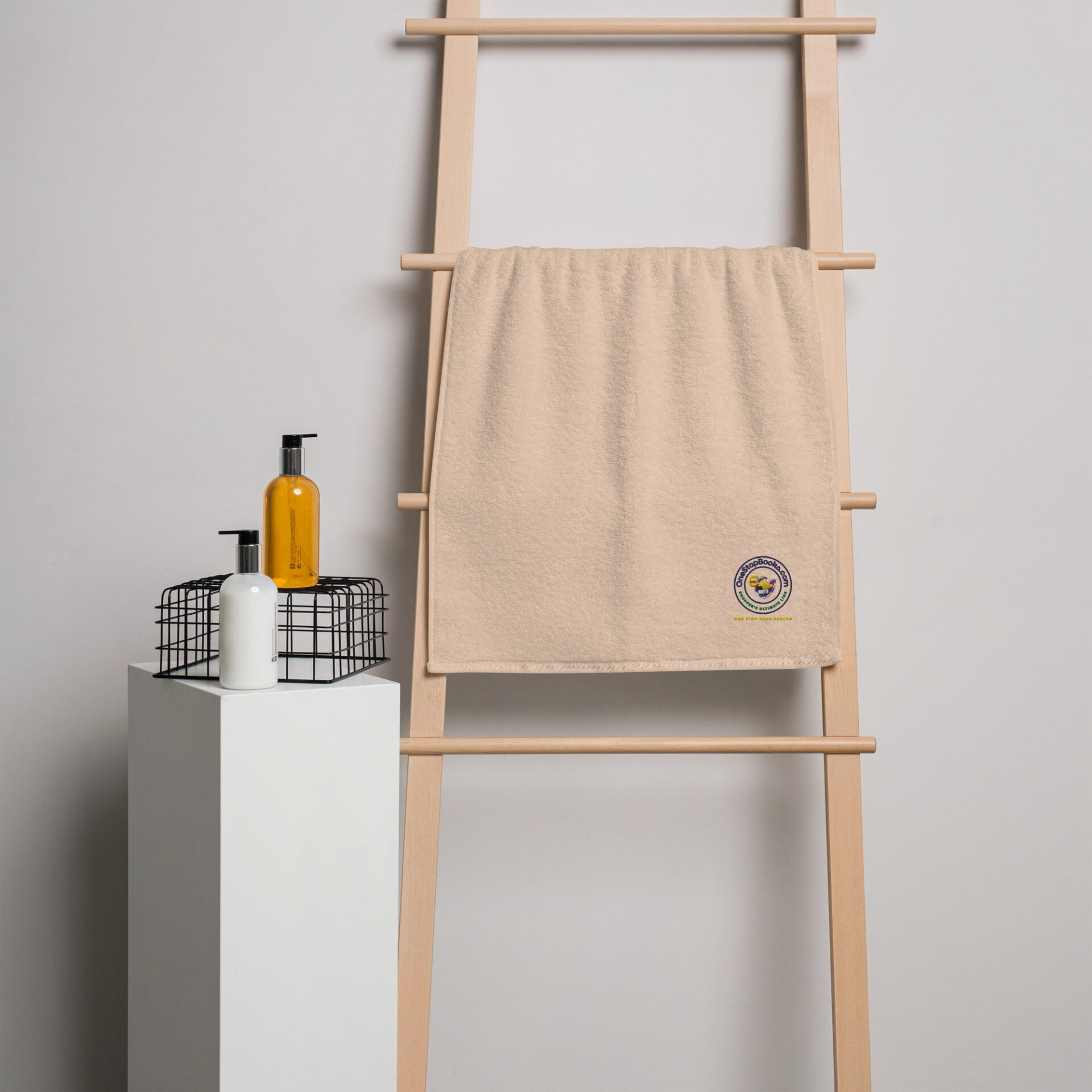 Beige towel hanging on wooden rack.