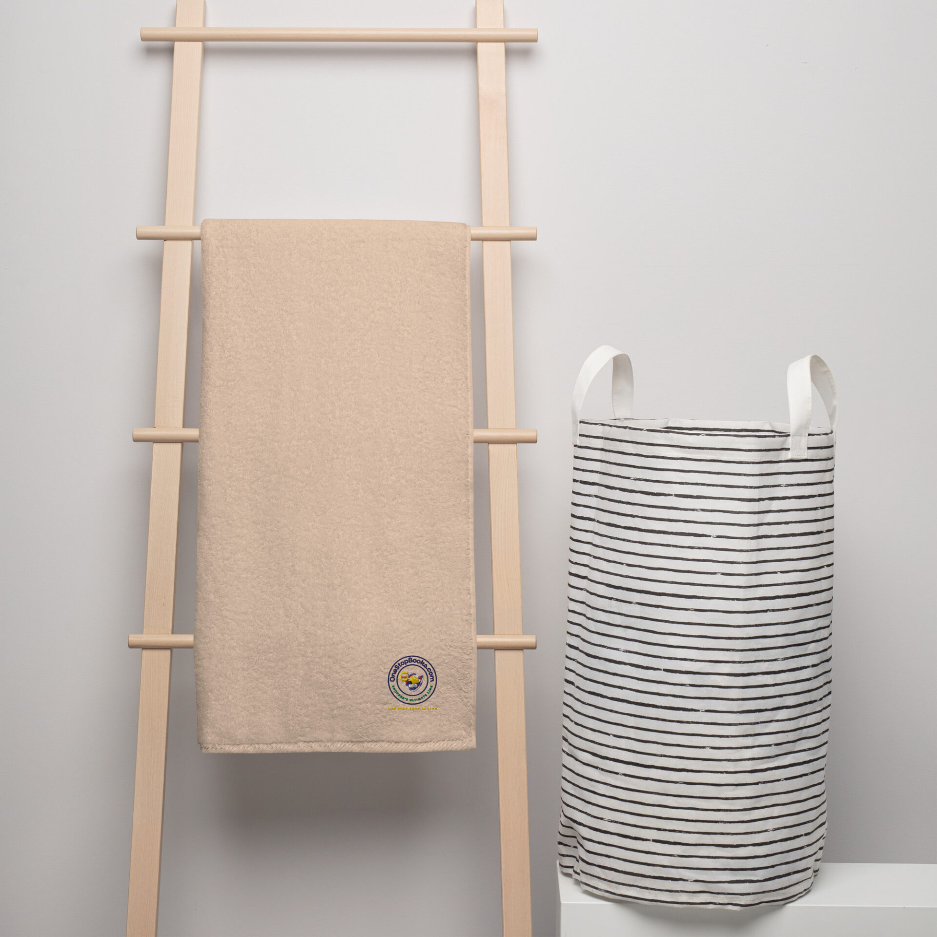 Beige towel and striped laundry basket.