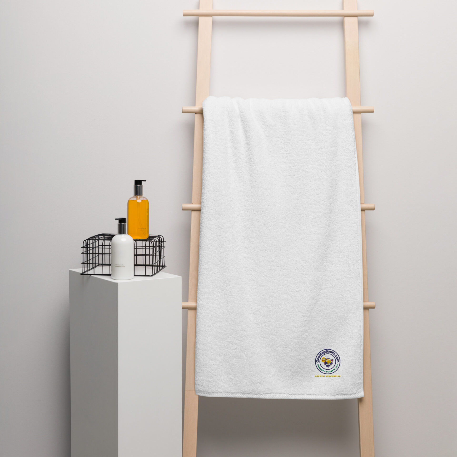 White towel on a wooden rack with logo.