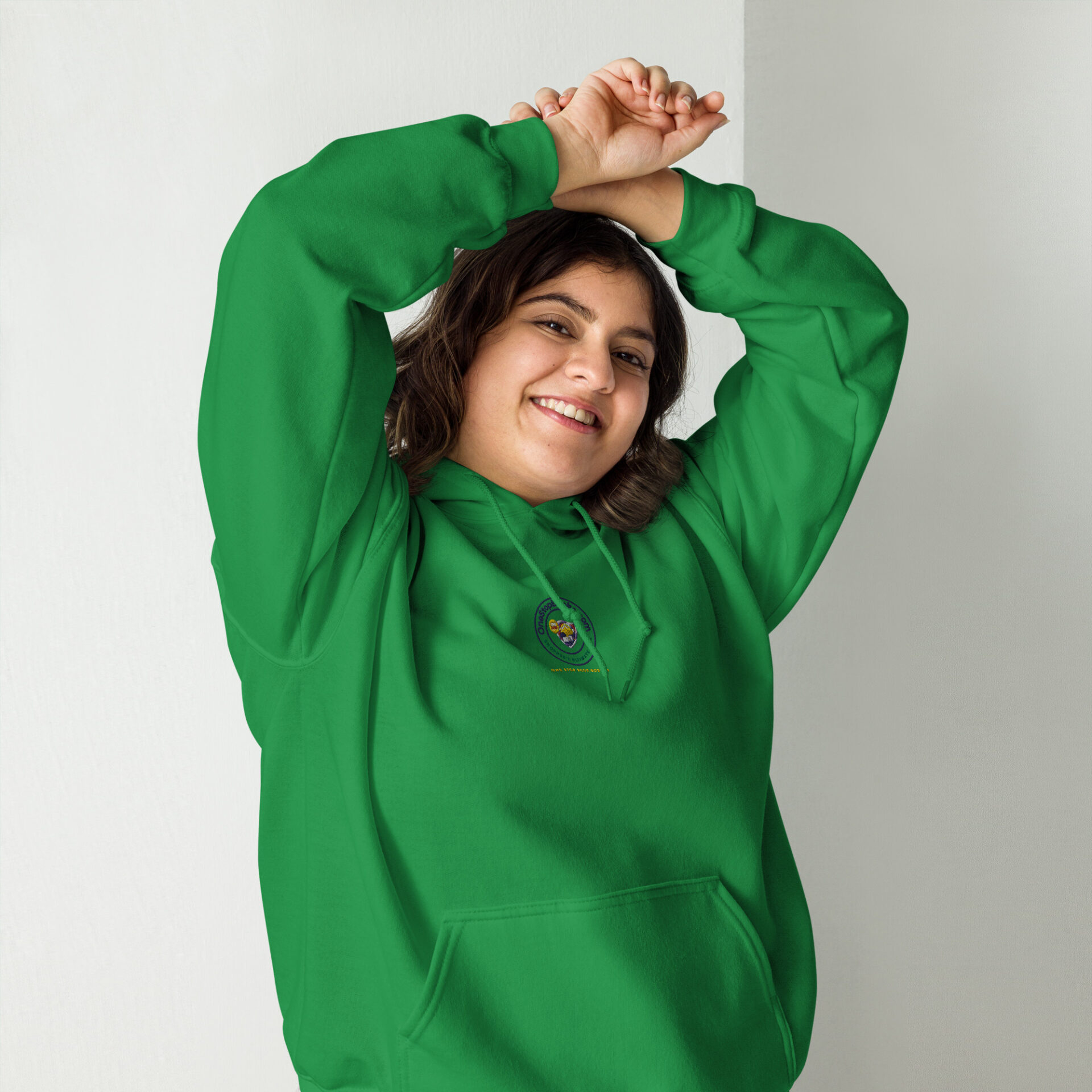 Woman in a green hoodie smiling.
