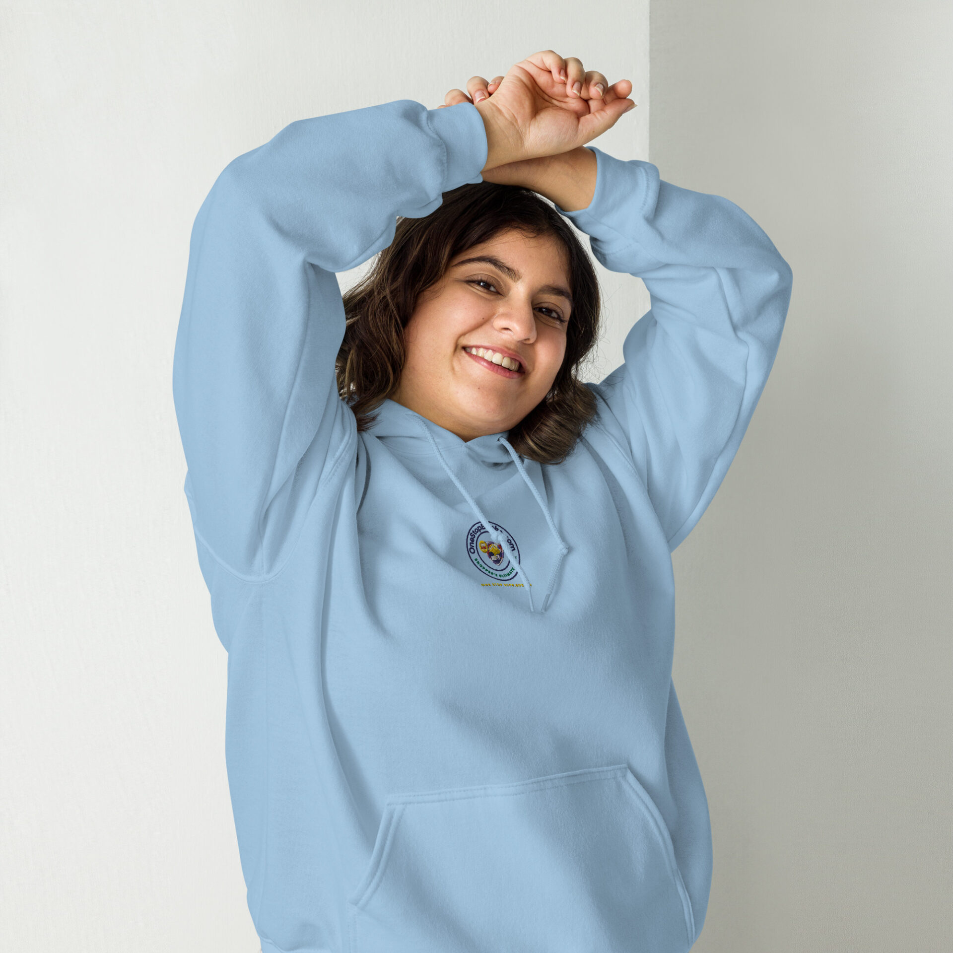 Woman smiling in light blue hoodie.