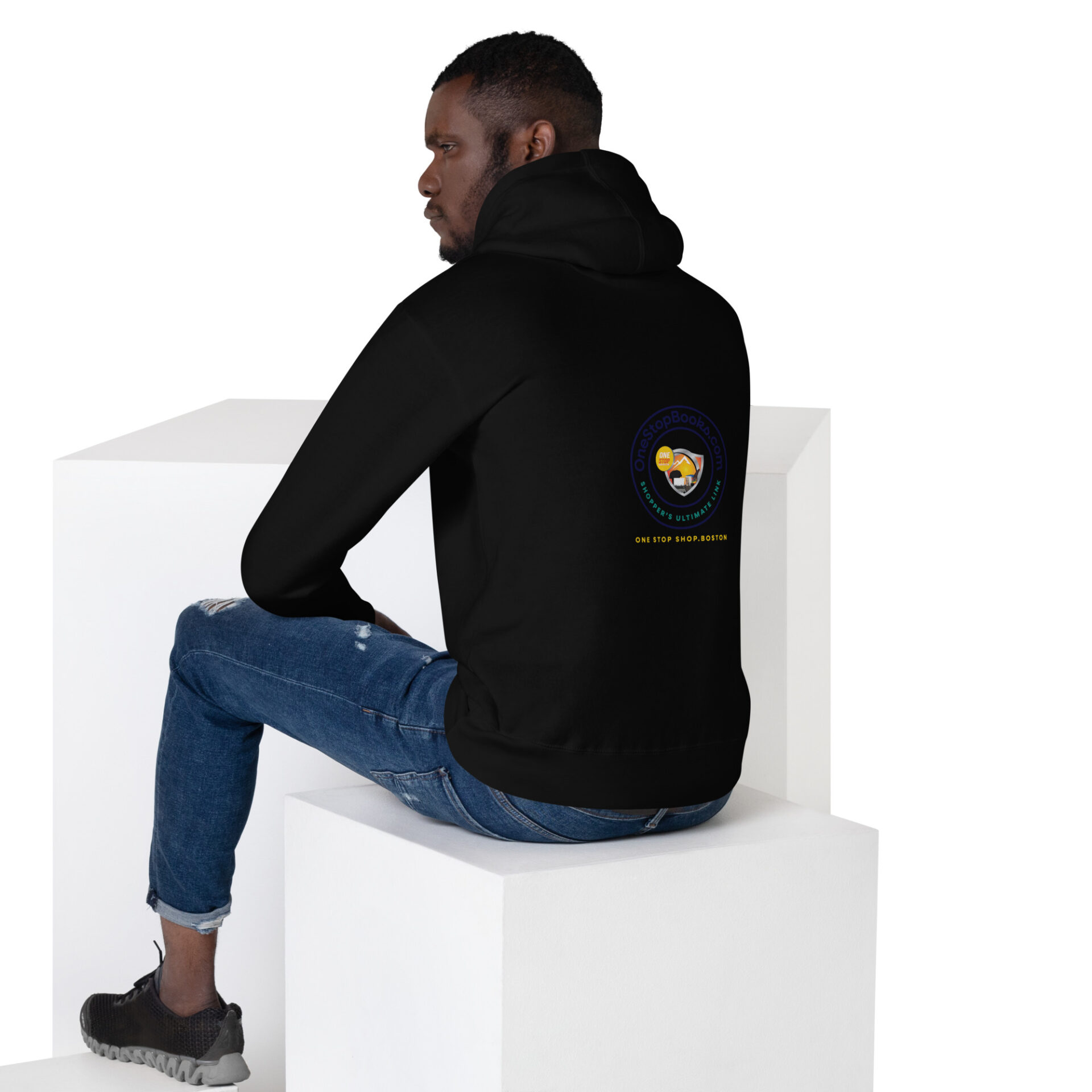 Man wearing black hoodie with logo on back.