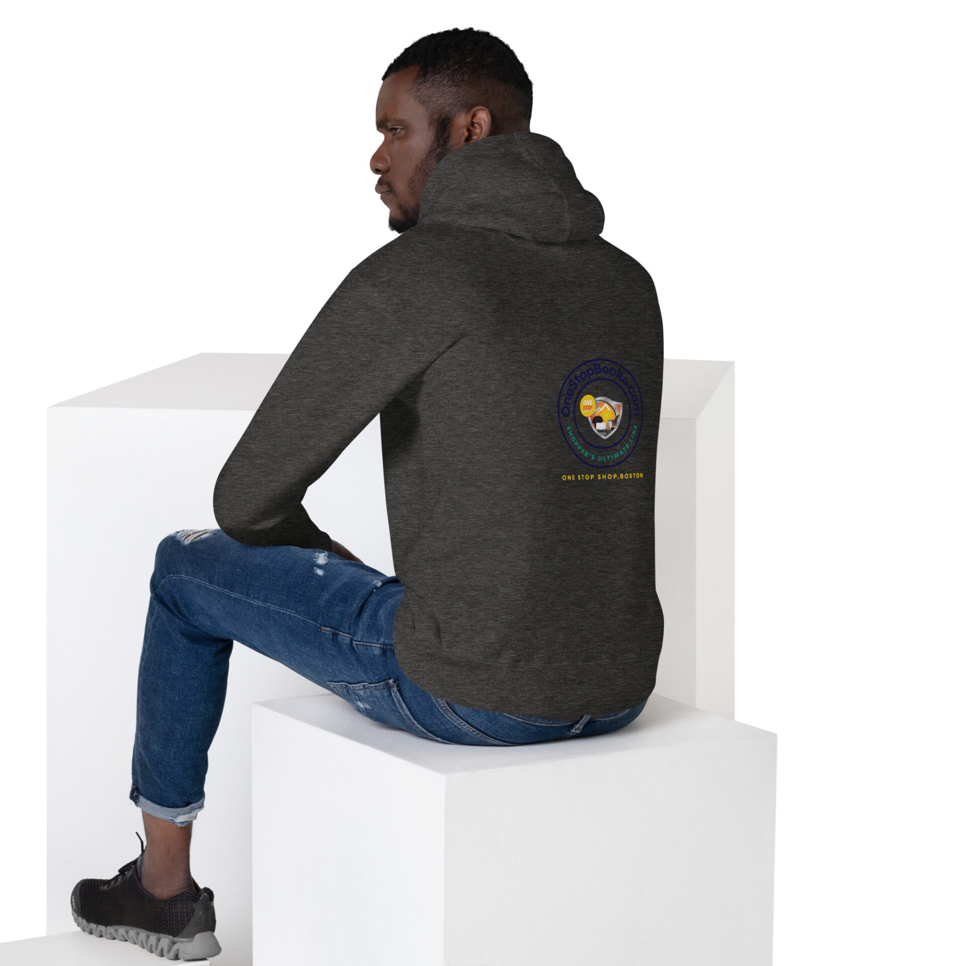 Man wearing a grey hoodie with a logo.