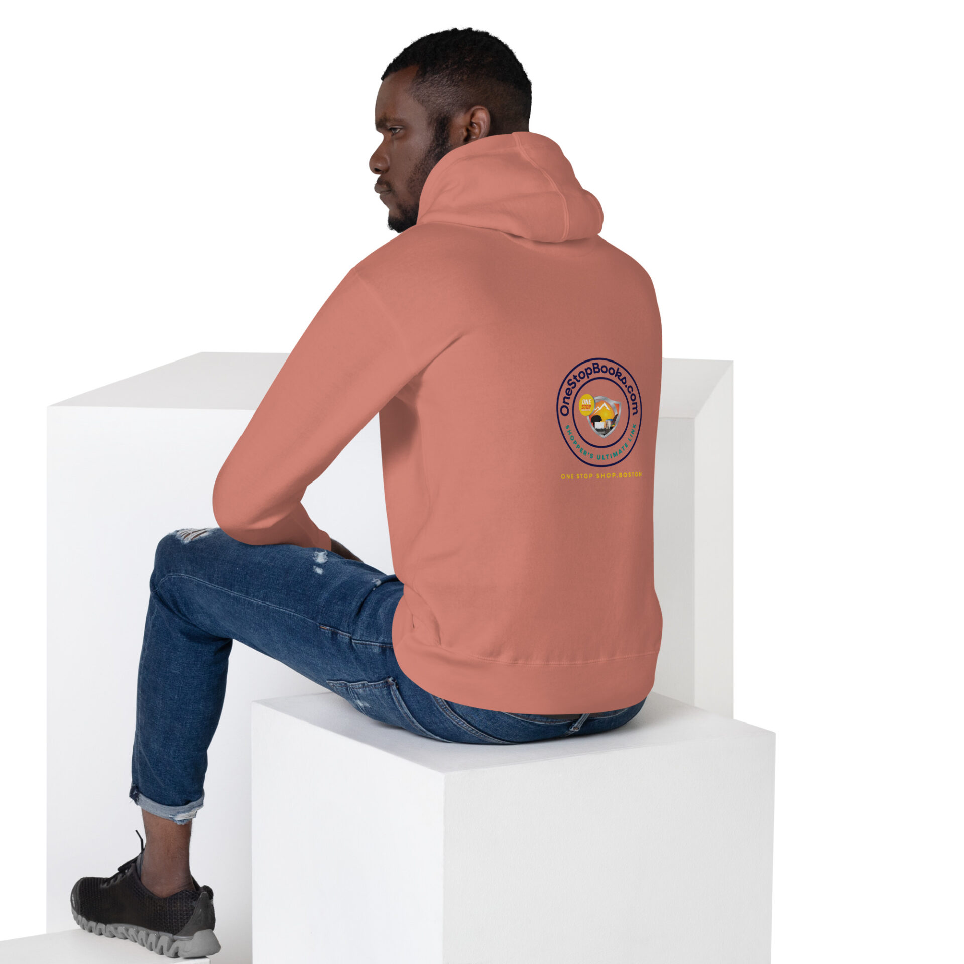 Man wearing a pink hoodie with a logo.