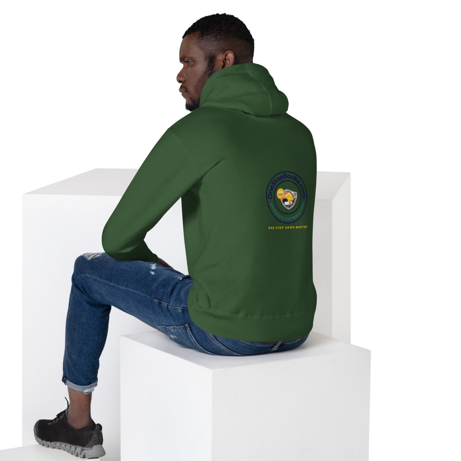 Man wearing a green hoodie with a logo.