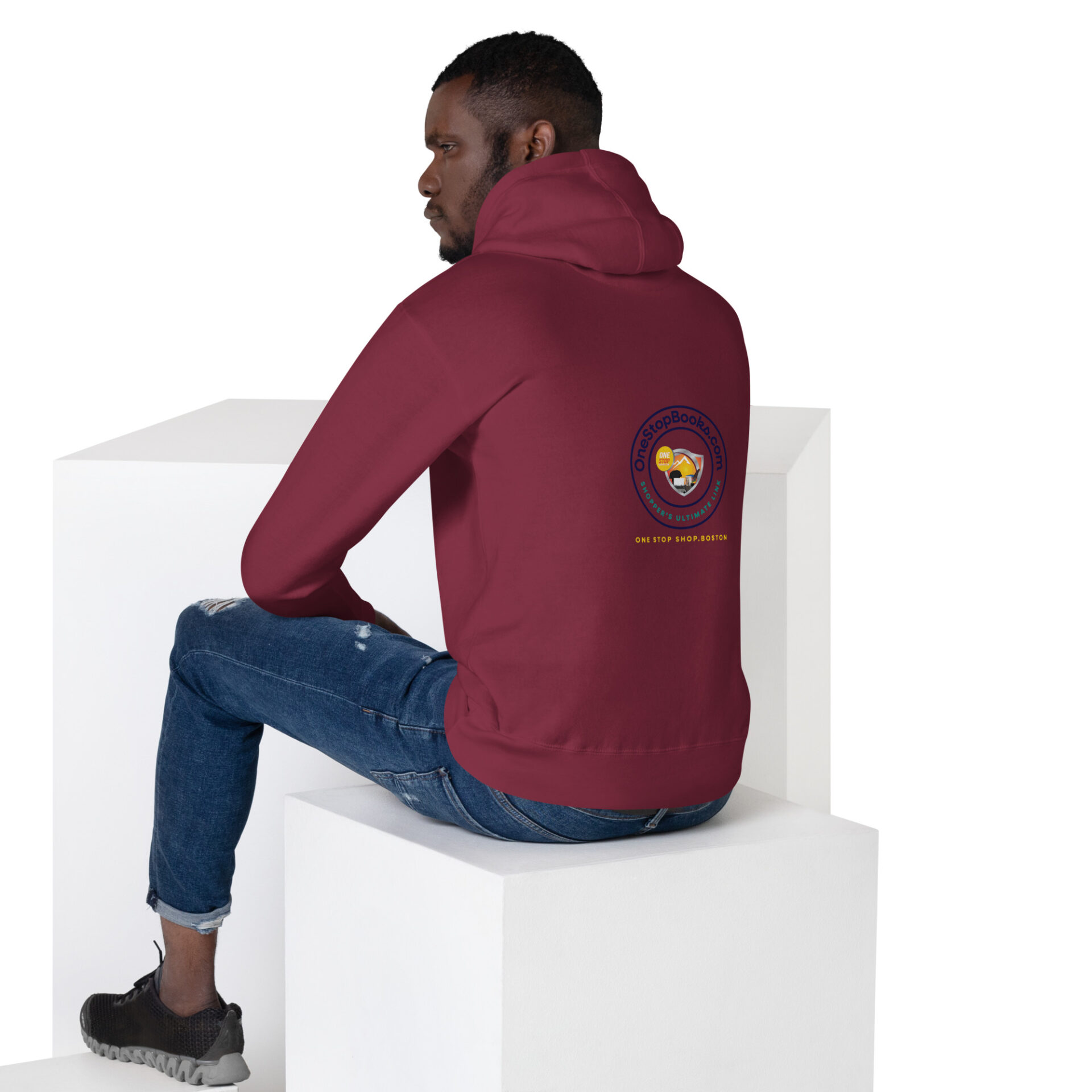 Man wearing a maroon hoodie with logo.