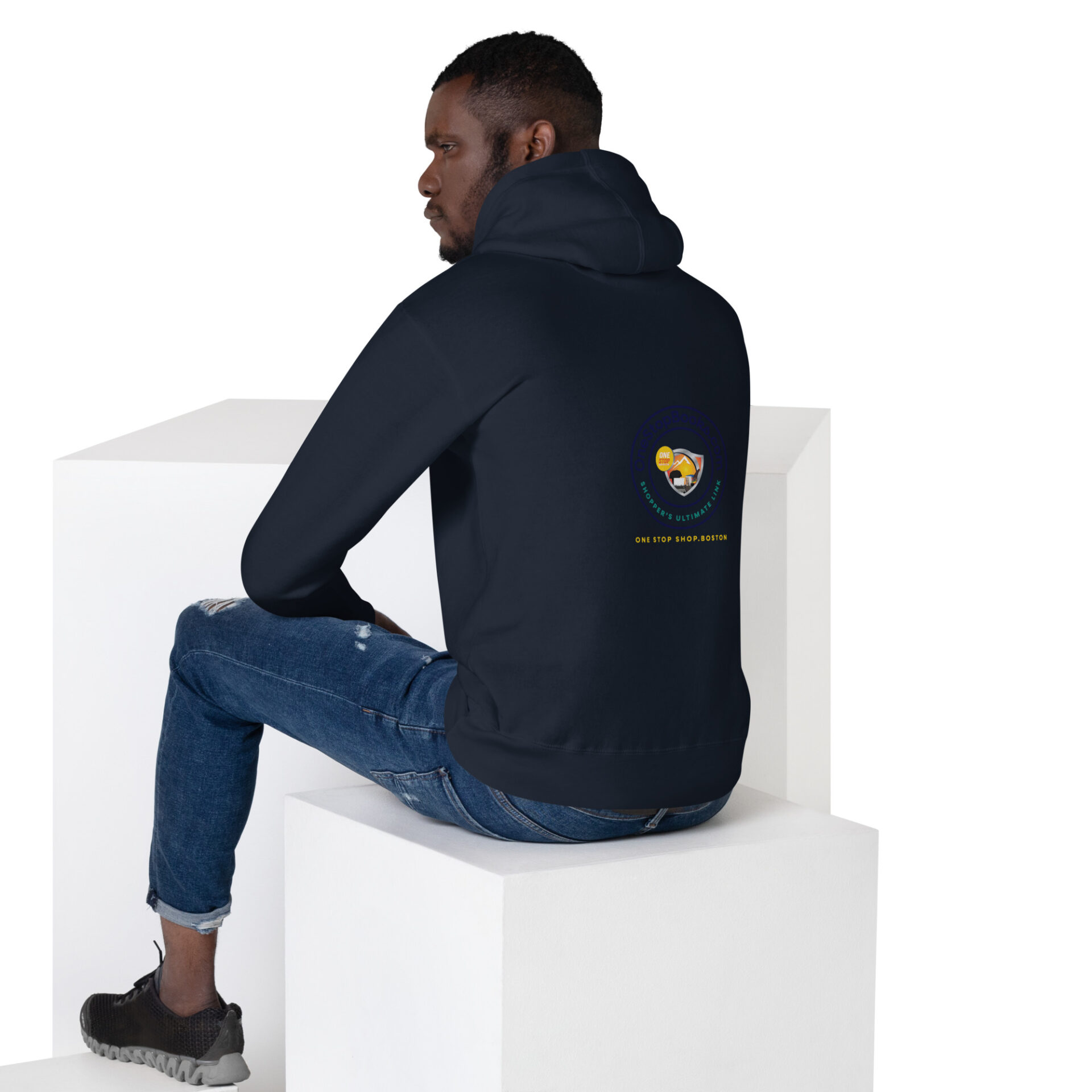 Man wearing a navy blue hoodie with a logo.
