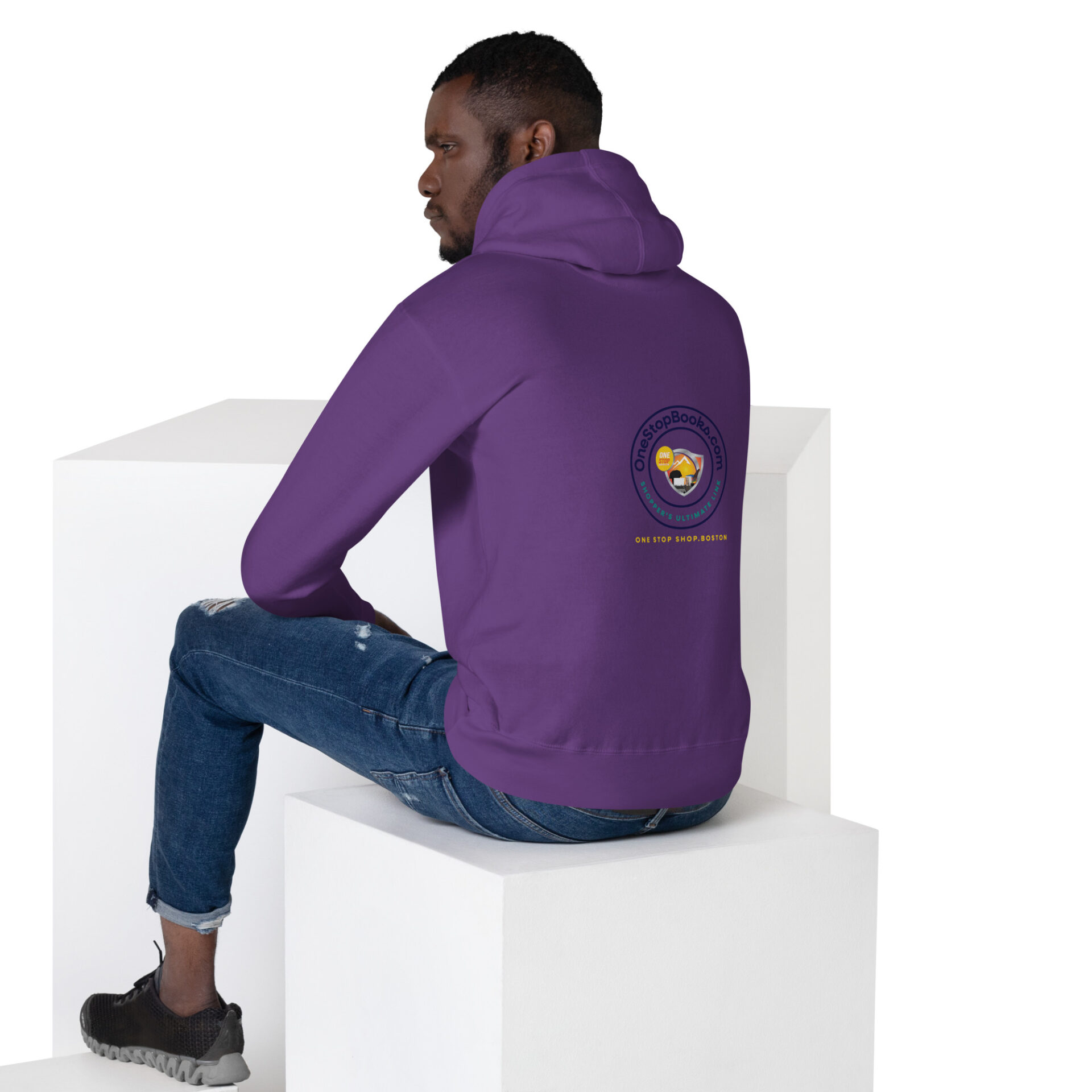 Man wearing a purple hoodie with a logo.
