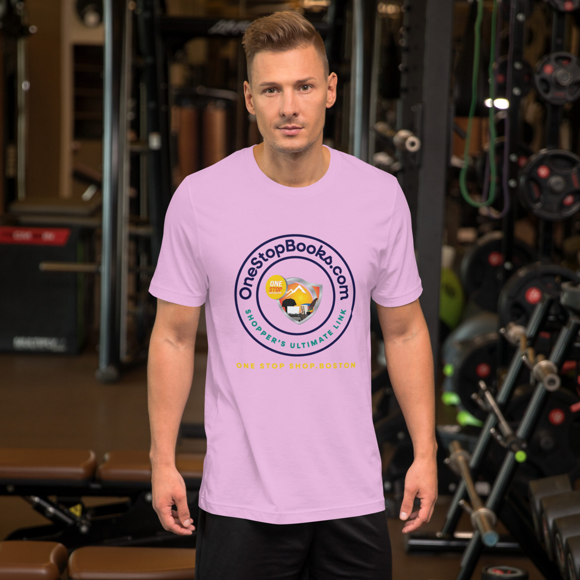 Man wearing a pink t-shirt with a logo.