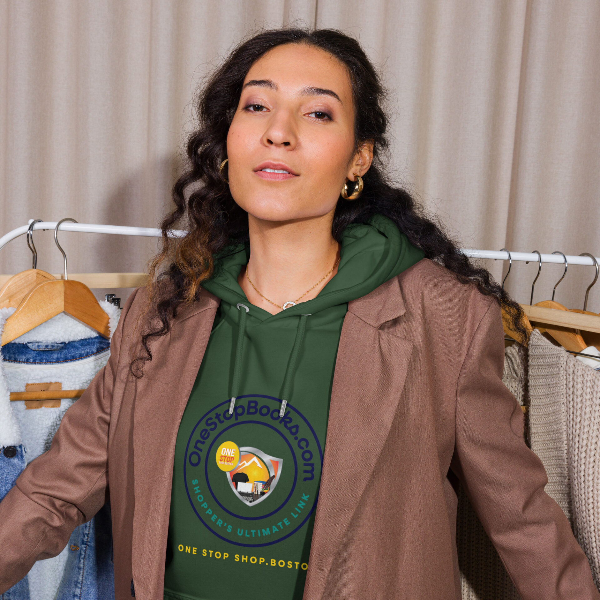 Woman wearing a green hoodie with a logo.
